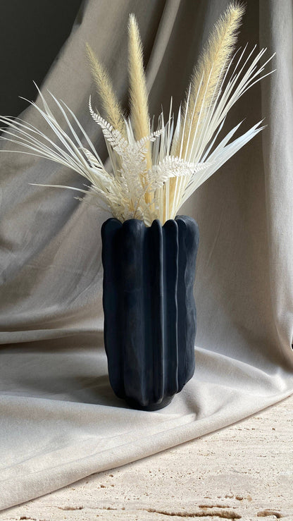 Forma concrete vase by Atelier La Rouleuse with a modern, minimalist design featuring a smooth, textured surface.