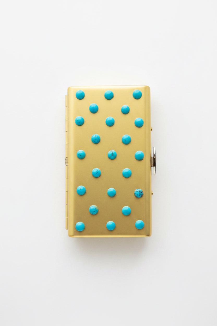 Turquoise cigarette case by P. Grunsfeld from The Vault Creative, featuring a vintage-style metal design with a textured finish.