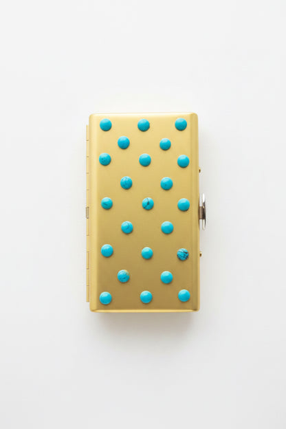 Turquoise cigarette case by P. Grunsfeld from The Vault Creative, featuring a vintage-style metal design with a textured finish.