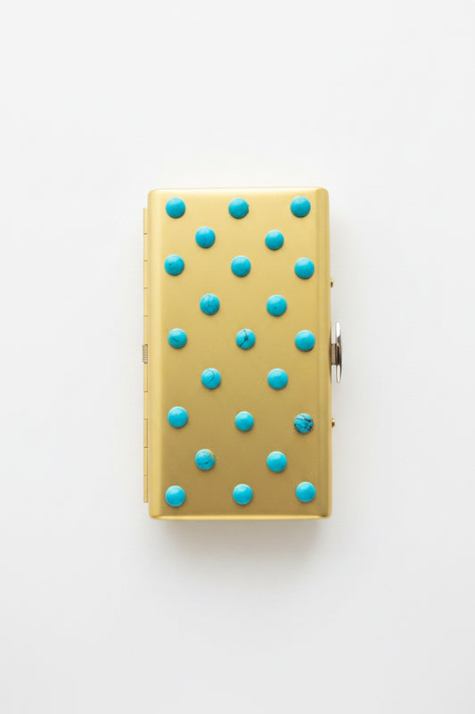 Turquoise cigarette case by P. Grunsfeld from The Vault Creative, featuring a vintage-style metal design with a textured finish.