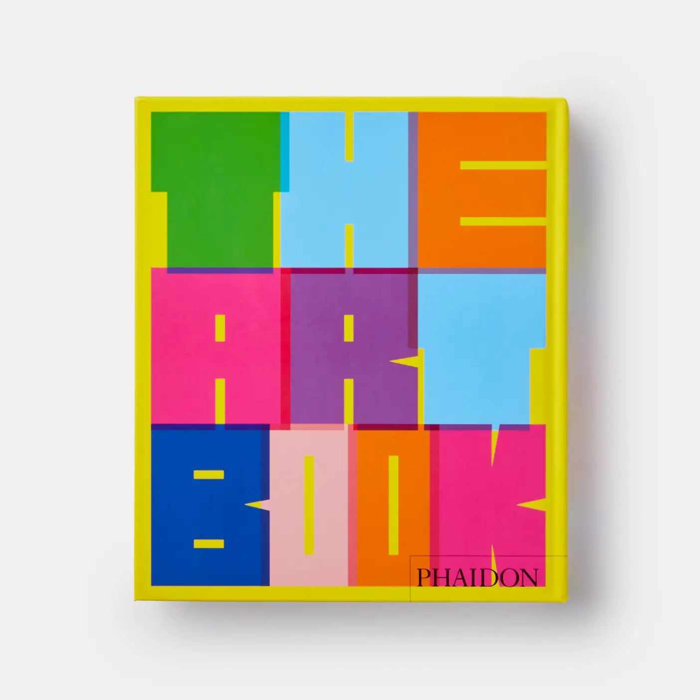 Open art book titled "Revised Edition" by Phaidon showing colorful contemporary artwork pages.
