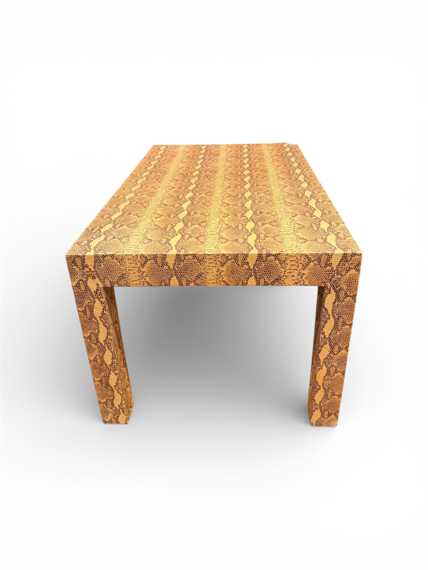Vintage custom snakeskin coffee table from The Vault Creative with a textured snakeskin surface and wooden legs.