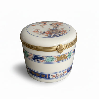 Vintage Limoges porcelain box with intricate floral design and gold accents, crafted by The Vault Creative.