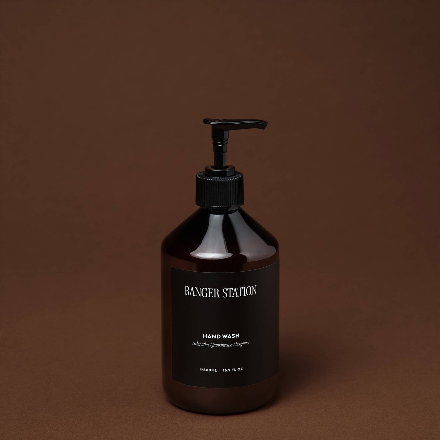 Ozmun Home Santalum Hand Wash bottle with pump dispenser, featuring a sleek design and scent of sandalwood in a modern setting.