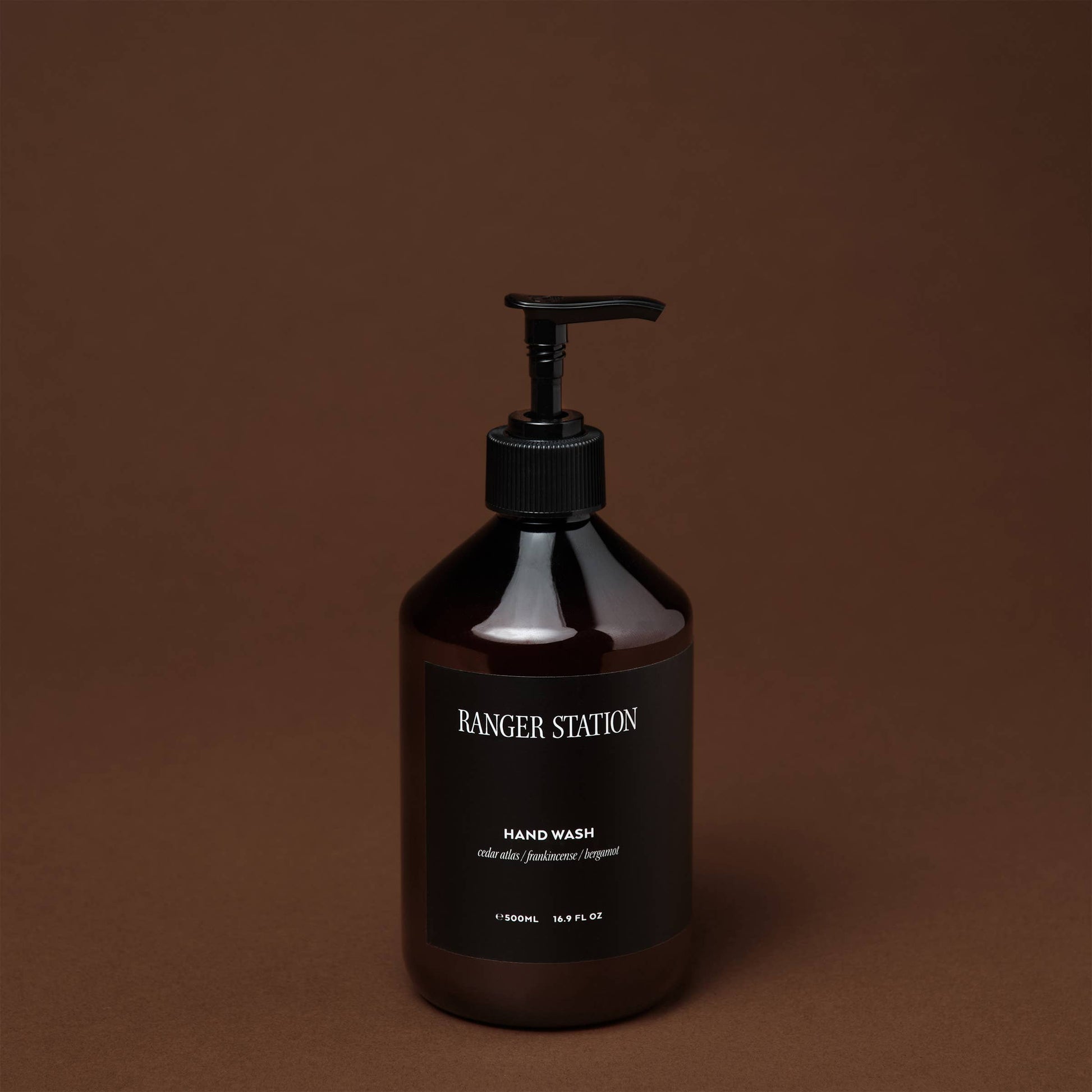 Ozmun Home Santalum Hand Wash bottle with pump dispenser, featuring a sleek design and scent of sandalwood in a modern setting.