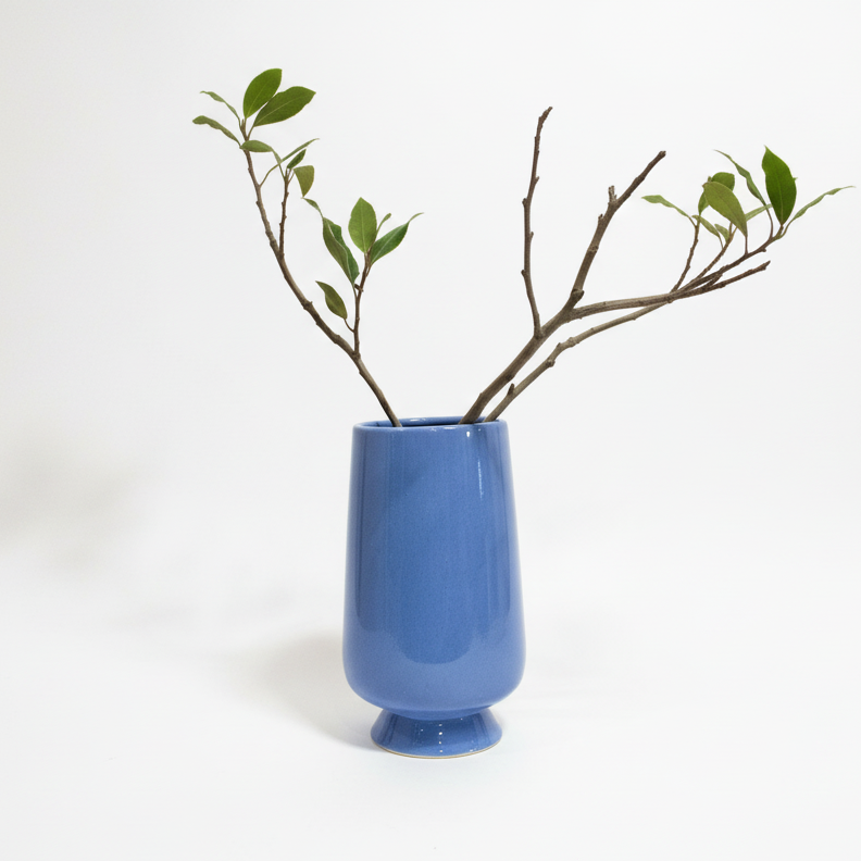 Purple vase by The Vault Creative with a sleek, modern design, showcasing a smooth surface and elegant shape.