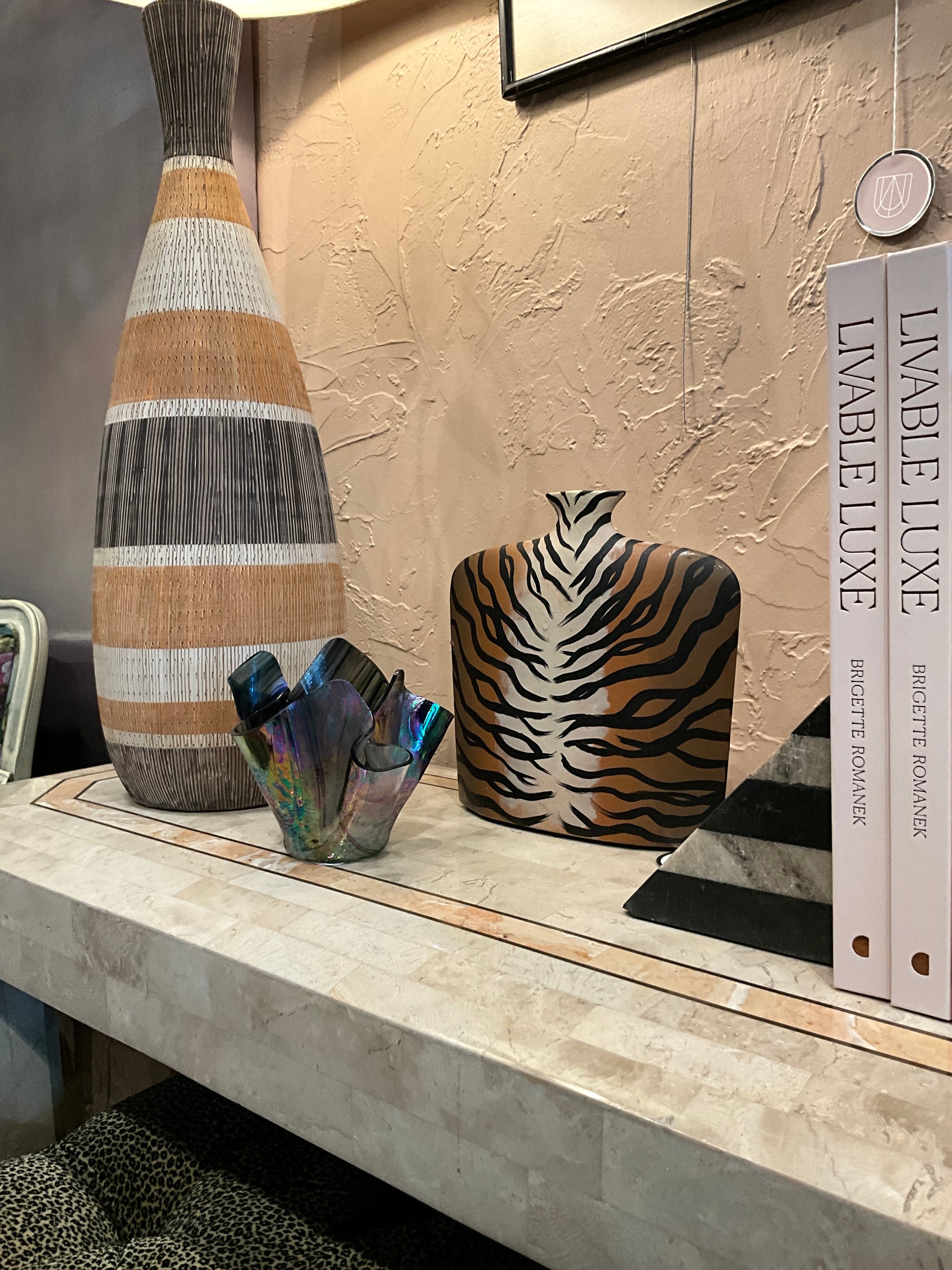 Hand-painted tiger stripe vase by Amber Rene Hansen featuring bold black and orange tiger stripe design on ceramic surface.