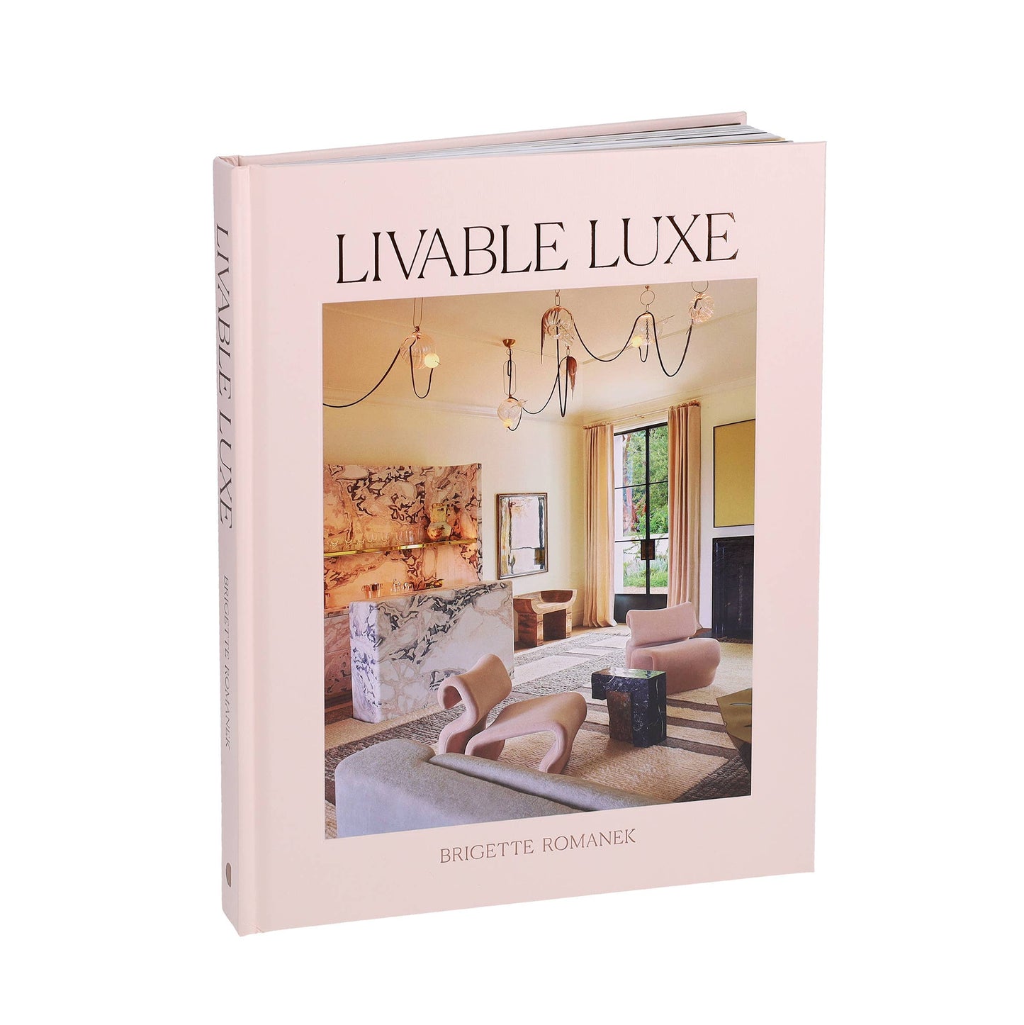 Open book titled Livable Luxe by Chronicle Books with stylish interior design images on pages.