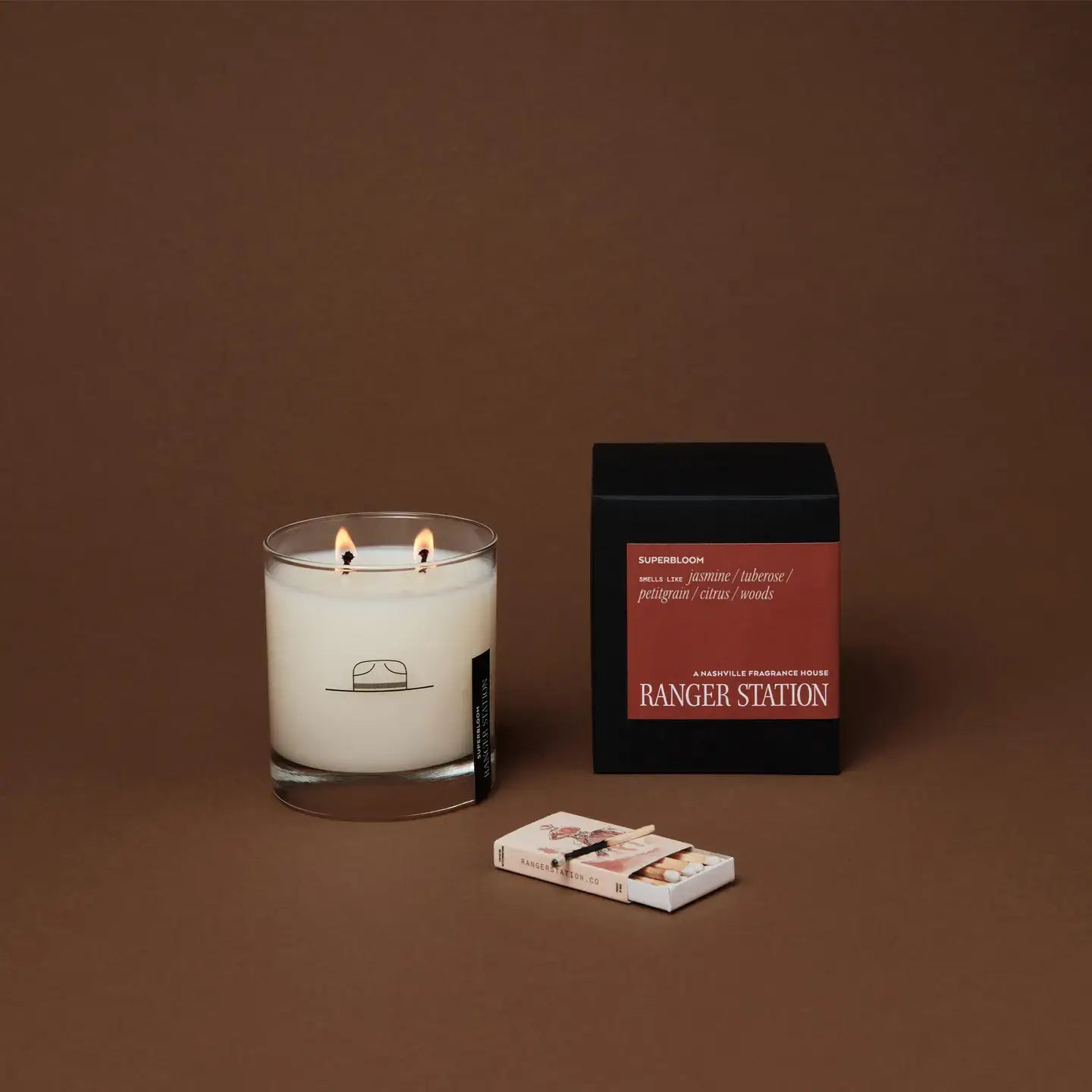 Ozmun Home Superbloom Candle with floral design and warm glow, perfect for cozy home decor and relaxing ambiance.