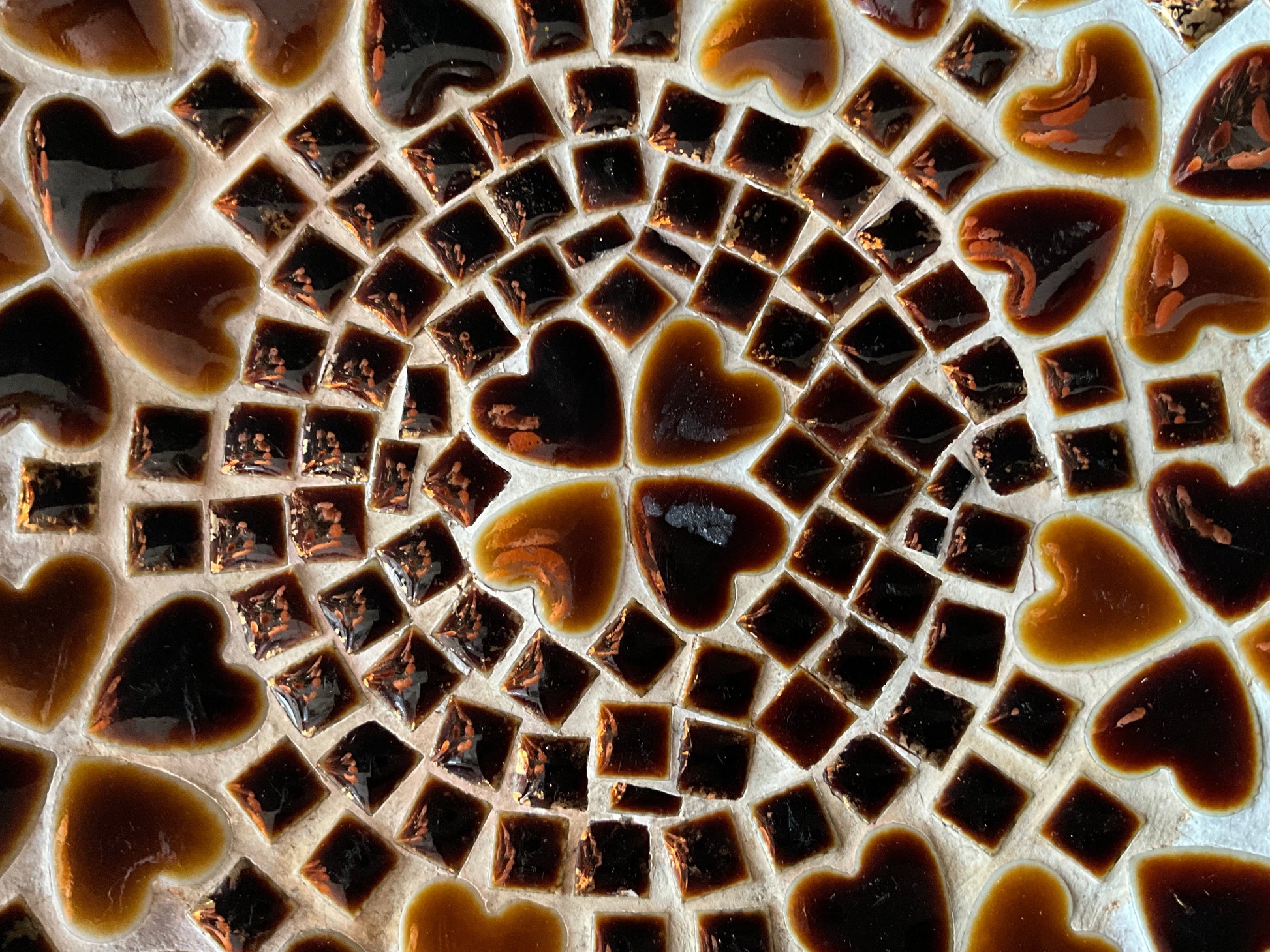 Heart mosaic plate by The Vault Creative featuring colorful glass tiles arranged in a heart shape.