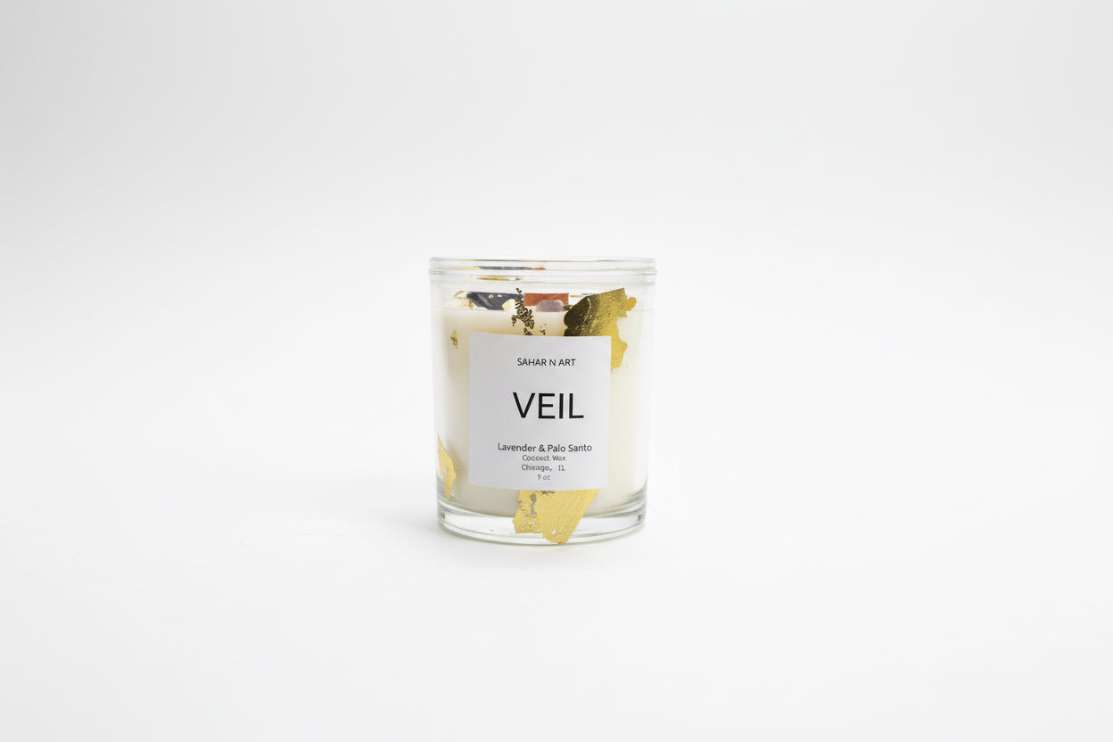 Ozmun Home Sahar N Art Candle featuring a decorative ceramic holder with intricate designs and a lit wax candle.