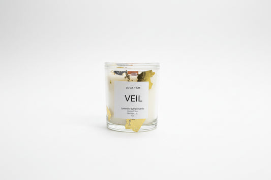 Ozmun Home Sahar N Art Candle featuring a decorative ceramic holder with intricate designs and a lit wax candle.