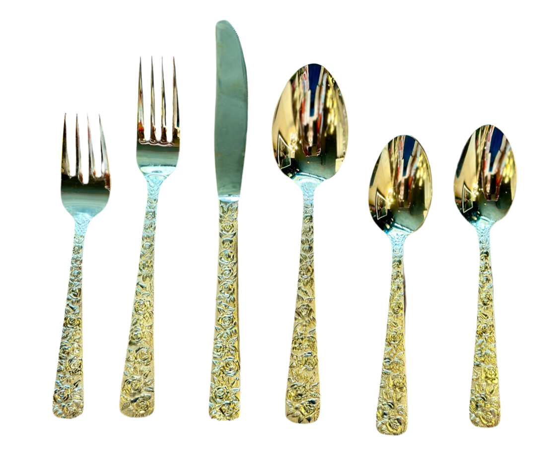The Vault Creative 8 settings gold-plated flatware set including forks, knives, and spoons arranged on a table.