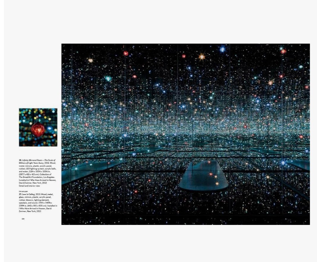 Open book titled "Yayoi Kusama: Infinity Mirrors" by Ozmun Home showcasing vibrant images of Kusama's iconic mirror art.