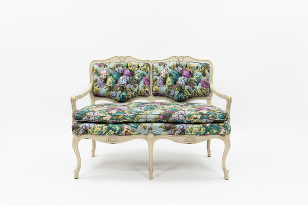 Small flower-patterned loveseat bench by The Vault Creative with cushioned seating and wooden legs.