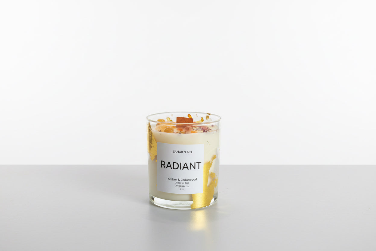 Sahar N Art Candle by Ozmun Home, decorative candle with intricate design in a clear glass holder on a wooden surface.