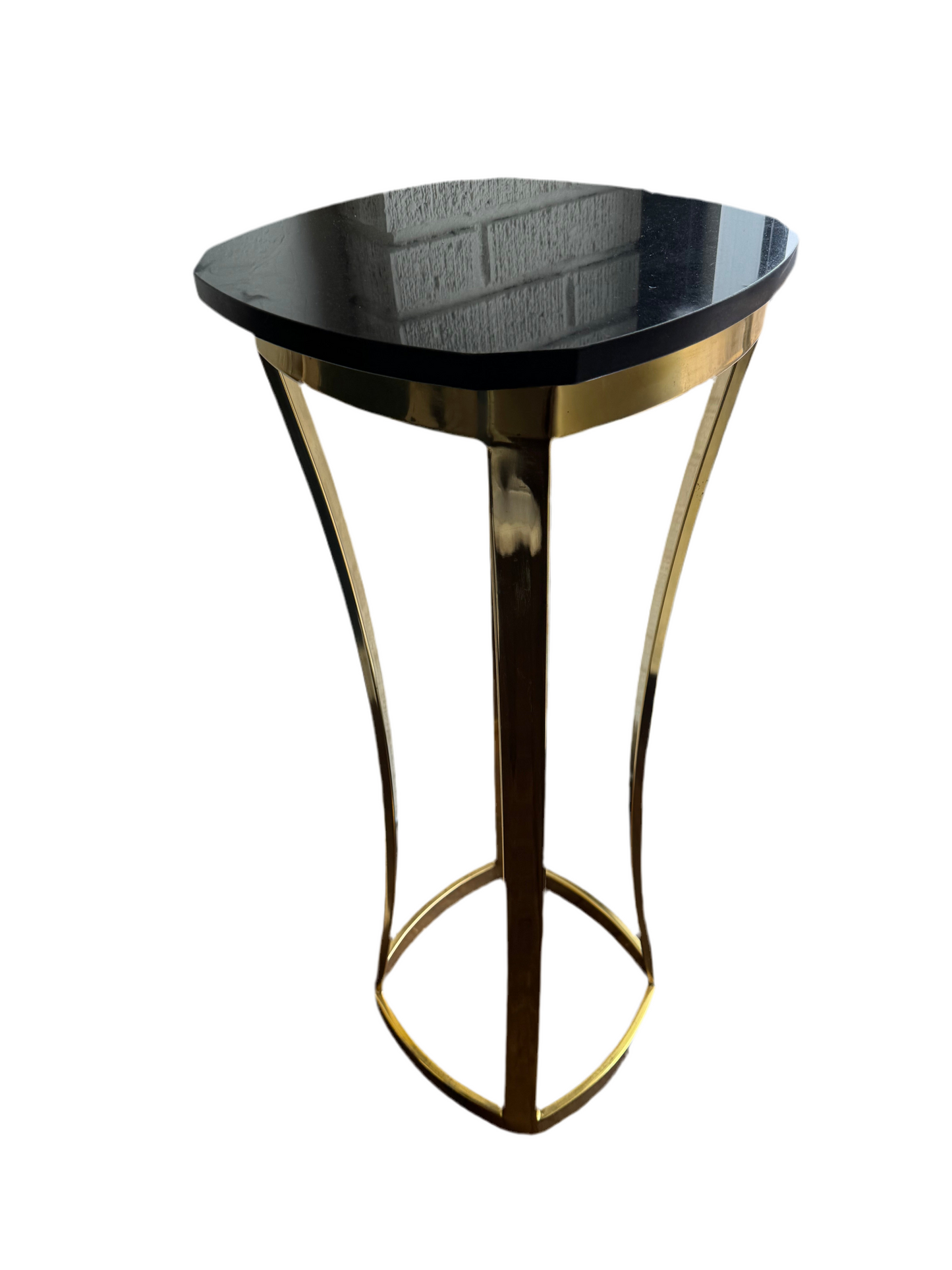 Brass and marble top pedestal by The Vault Creative, featuring a sleek, modern design with a brass base and marble top.