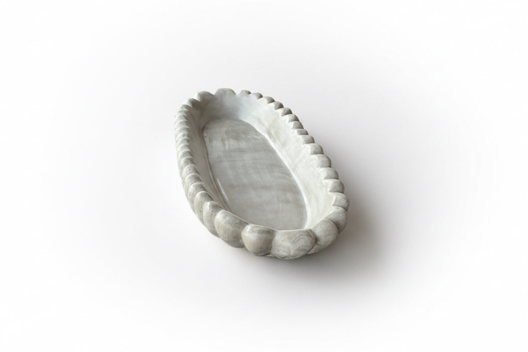 Handmade concrete bowl with antique marble finish by Atelier La Rouleuse, showcasing its textured surface and artisanal design.