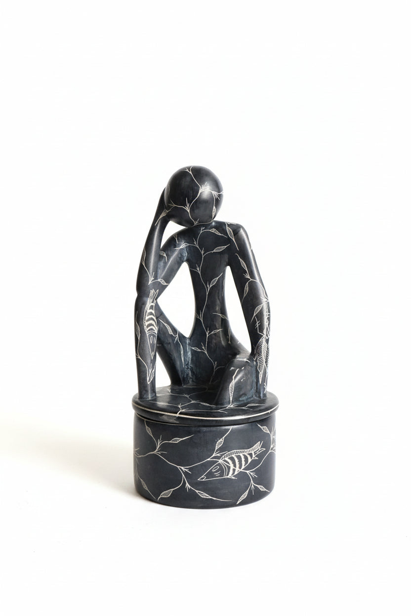French carved ceramic jar by The Vault Creative with intricate patterns and a glossy finish, displayed on a neutral background.