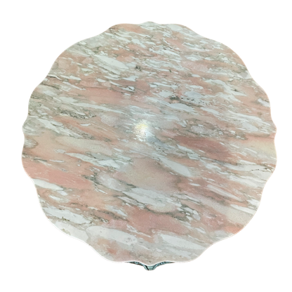 Pink marble coffee table by Ozmun Home with sleek round surface and modern design, perfect for contemporary living rooms.