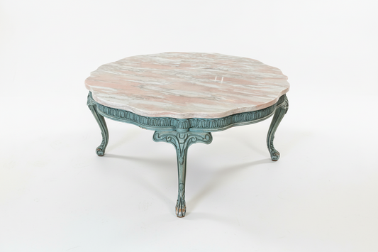 Pink marble coffee table by Ozmun Home with sleek modern design and rounded edges, showcasing elegant marble surface and wooden legs.