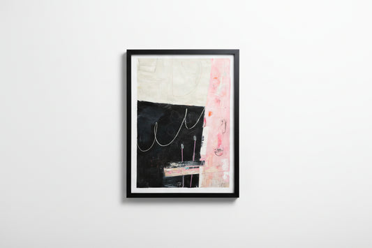 Framed abstract art piece on a white wall