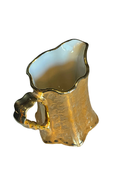 Weeping Gold ceramic pitcher by The Vault Creative with a glossy gold finish and elegant curved design.