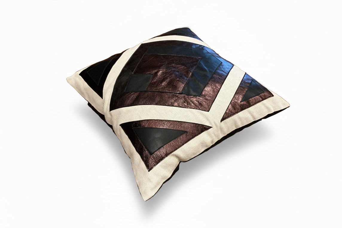 Leather patchwork pillow by The Vault Creative featuring mixed leather patches and a soft, textured cushion surface.