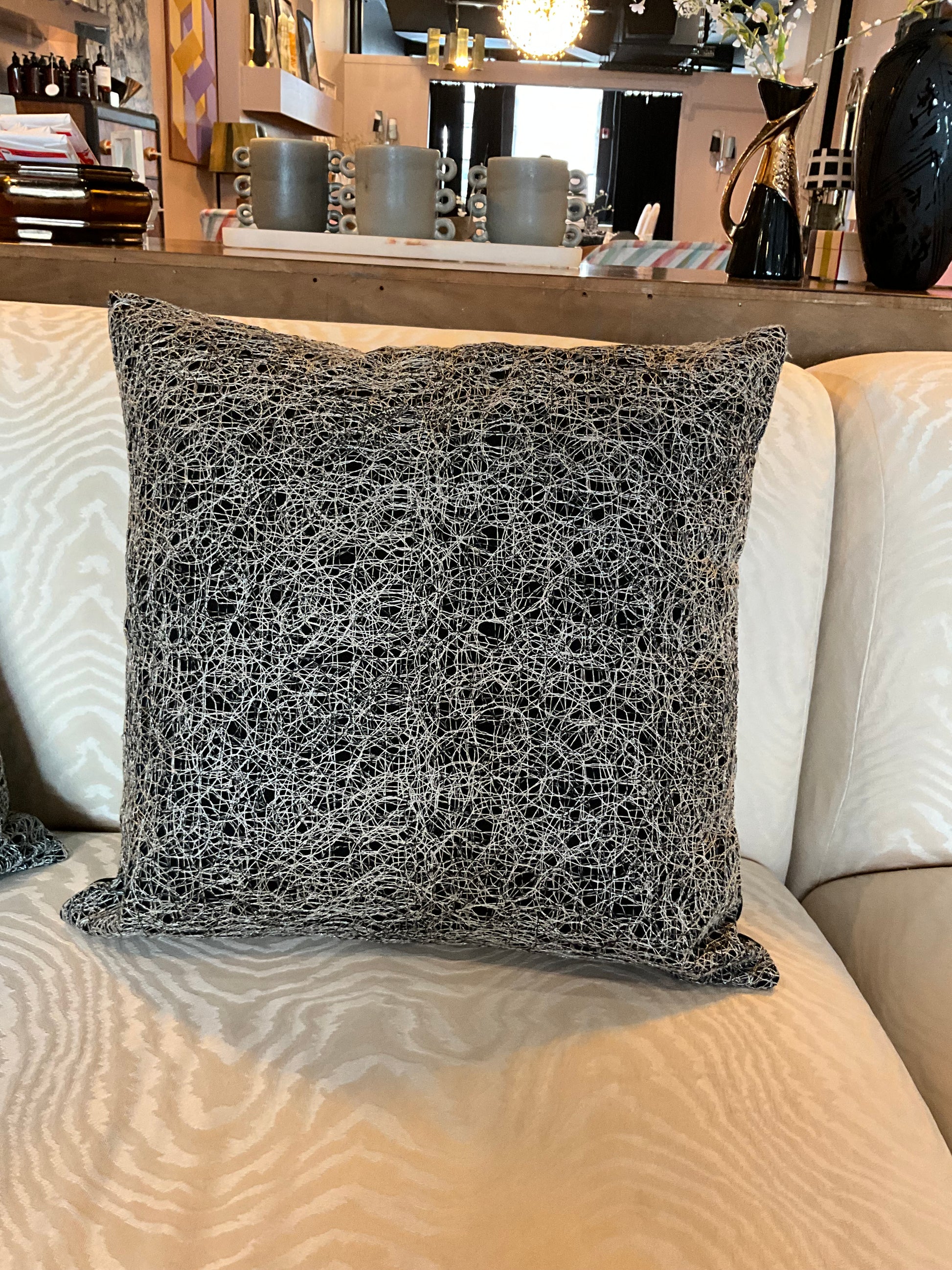 Silver and black metallic pillow by The Vault Creative with plush fabric and stylish design.