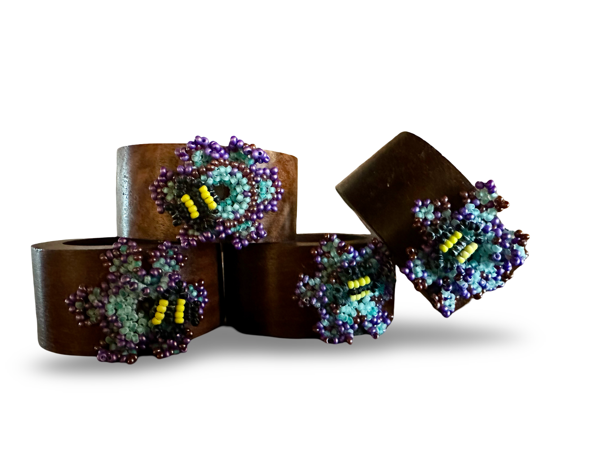 Handmade bee-shaped napkin rings by Phoebe, featuring detailed bee design on circular rings for table decor.