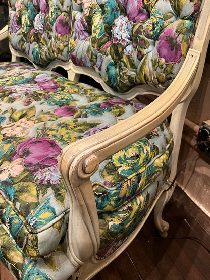 Small floral loveseat bench by The Vault Creative with cushioned seat and wooden legs, perfect for compact living spaces.