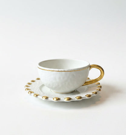 Set of four Vietri cup and saucer sets by ST x OH, featuring colorful ceramic designs on white porcelain.