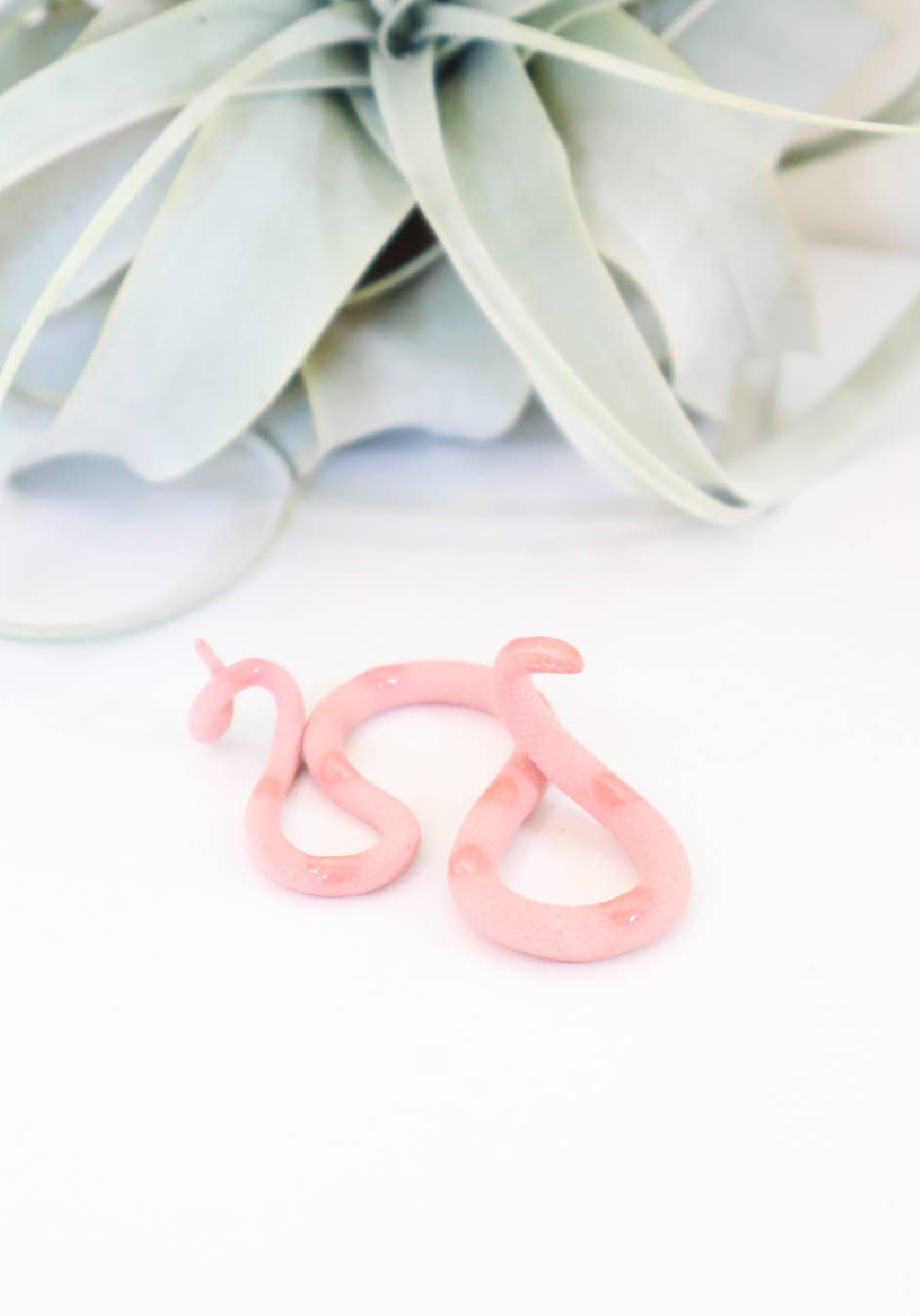 Colorful strawberry snake plush toy from The Vault Creative, featuring a vibrant, soft fabric snake with a strawberry pattern.