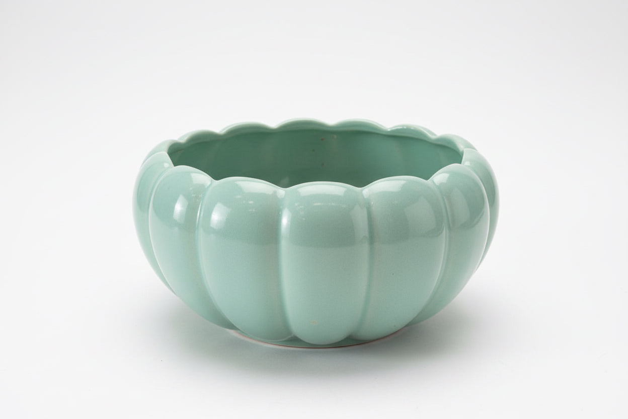 Mint green ceramic bowl from The Vault Creative with a smooth, rounded shape and glossy finish.