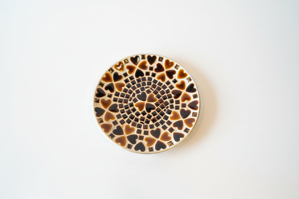 Colorful heart mosaic plate by The Vault Creative with intricate tile design and vibrant pattern on a ceramic surface.