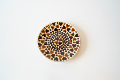 Colorful heart mosaic plate by The Vault Creative with intricate tile design and vibrant pattern on a ceramic surface.