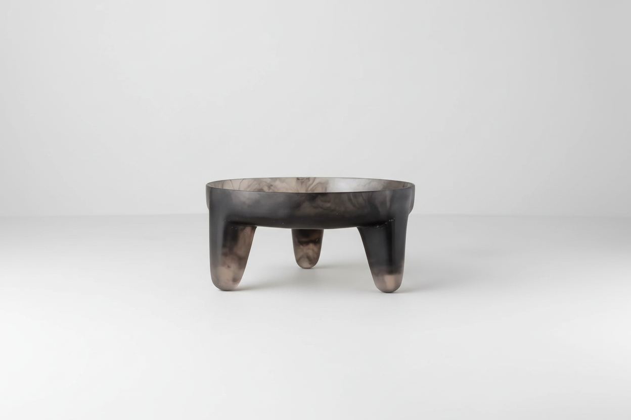 Saardé smoke-colored resin structured fruit bowl with a modern, textured design on a neutral surface.