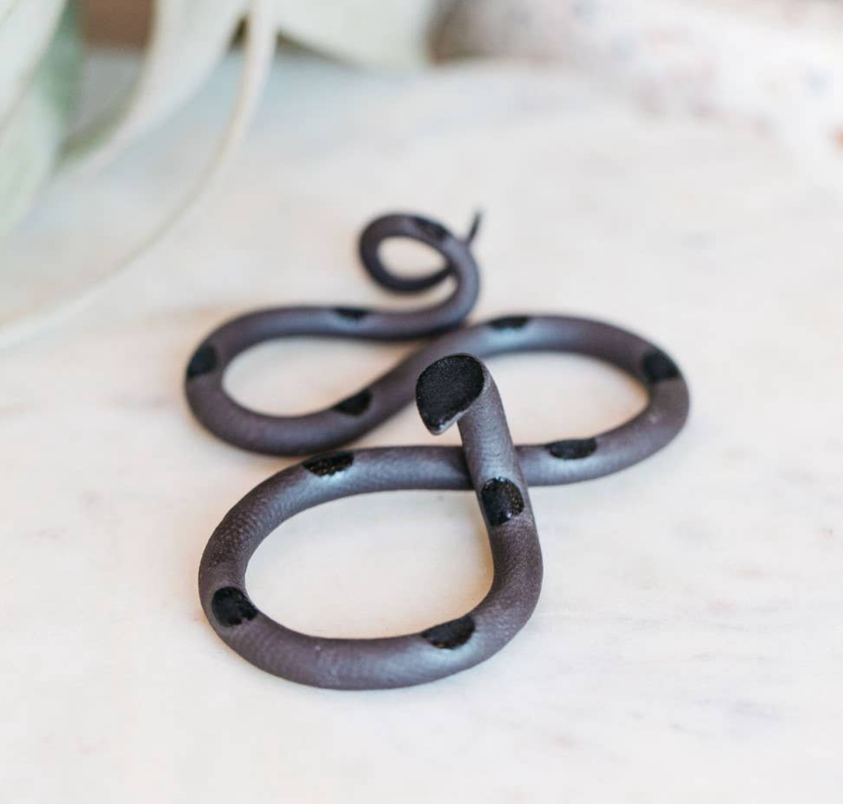 The Vault Creative Saul snake sculpture featuring a sleek, metallic design with intricate details and smooth curves.