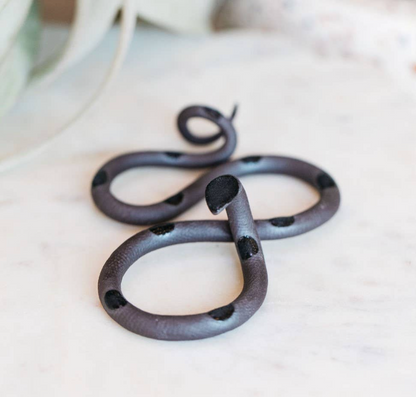 The Vault Creative Saul snake sculpture featuring a sleek, metallic design with intricate details and smooth curves.