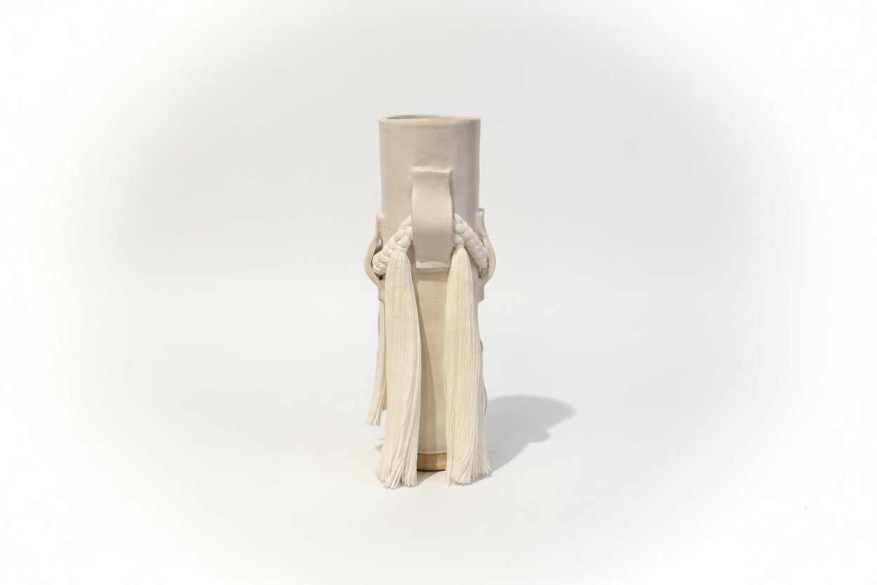 White ceramic vase by Karen Tinney from The Vault Creative, shown with a smooth, rounded design and a narrow opening.