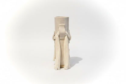 White ceramic vase by Karen Tinney from The Vault Creative, shown with a smooth, rounded design and a narrow opening.