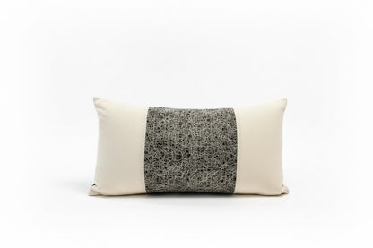 Small lumbar pillow by Stone Textile with soft fabric cover, designed to provide lower back support and comfort.