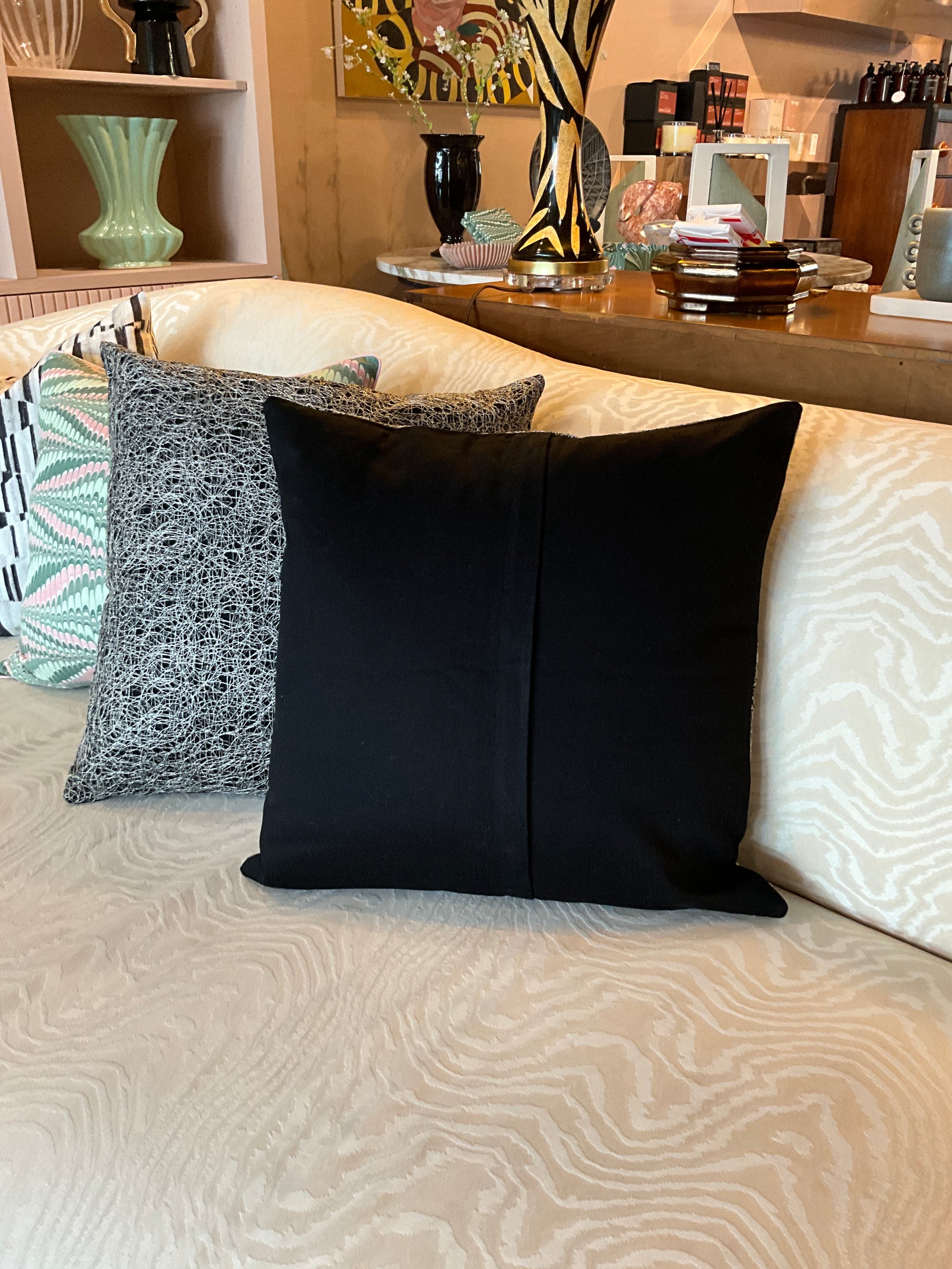 Silver and black metallic pillow from The Vault Creative with a shiny, textured surface for modern home decor.