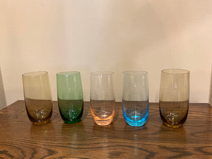 Five tall colored drinking glasses from The Vault Creative, featuring vibrant hues and clear glass design.