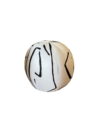 French Ball Pillow by The Vault Creative featuring a soft, round decorative cushion with a textured fabric cover.