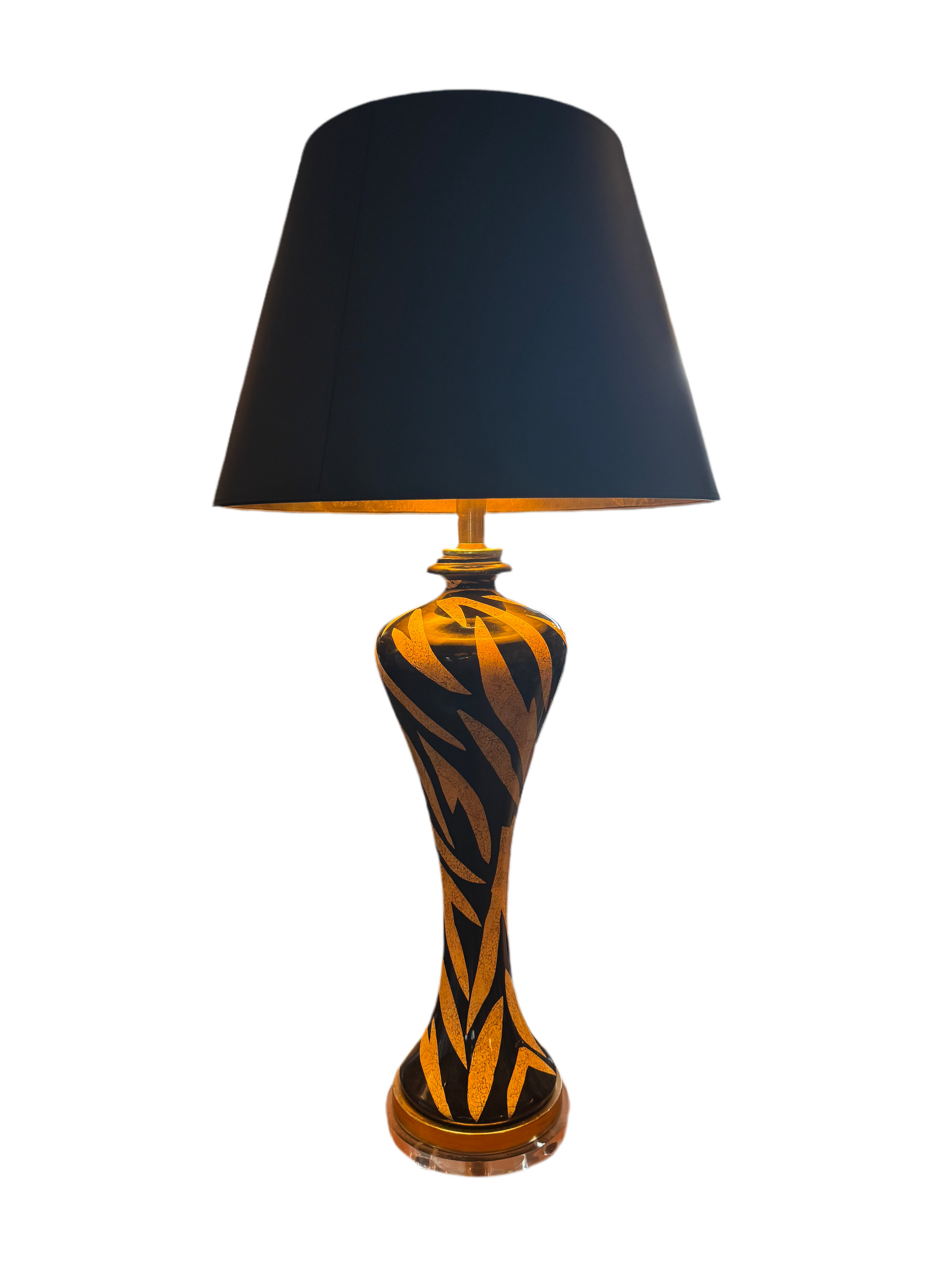 Tiger striped lamp by The Vault Creative, featuring bold black and orange tiger stripe design with a modern base.