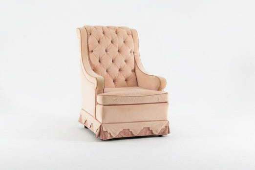 Vintage pink chair by The Vault Creative with elegant wooden legs and plush upholstery, ideal for classic or shabby chic decor.