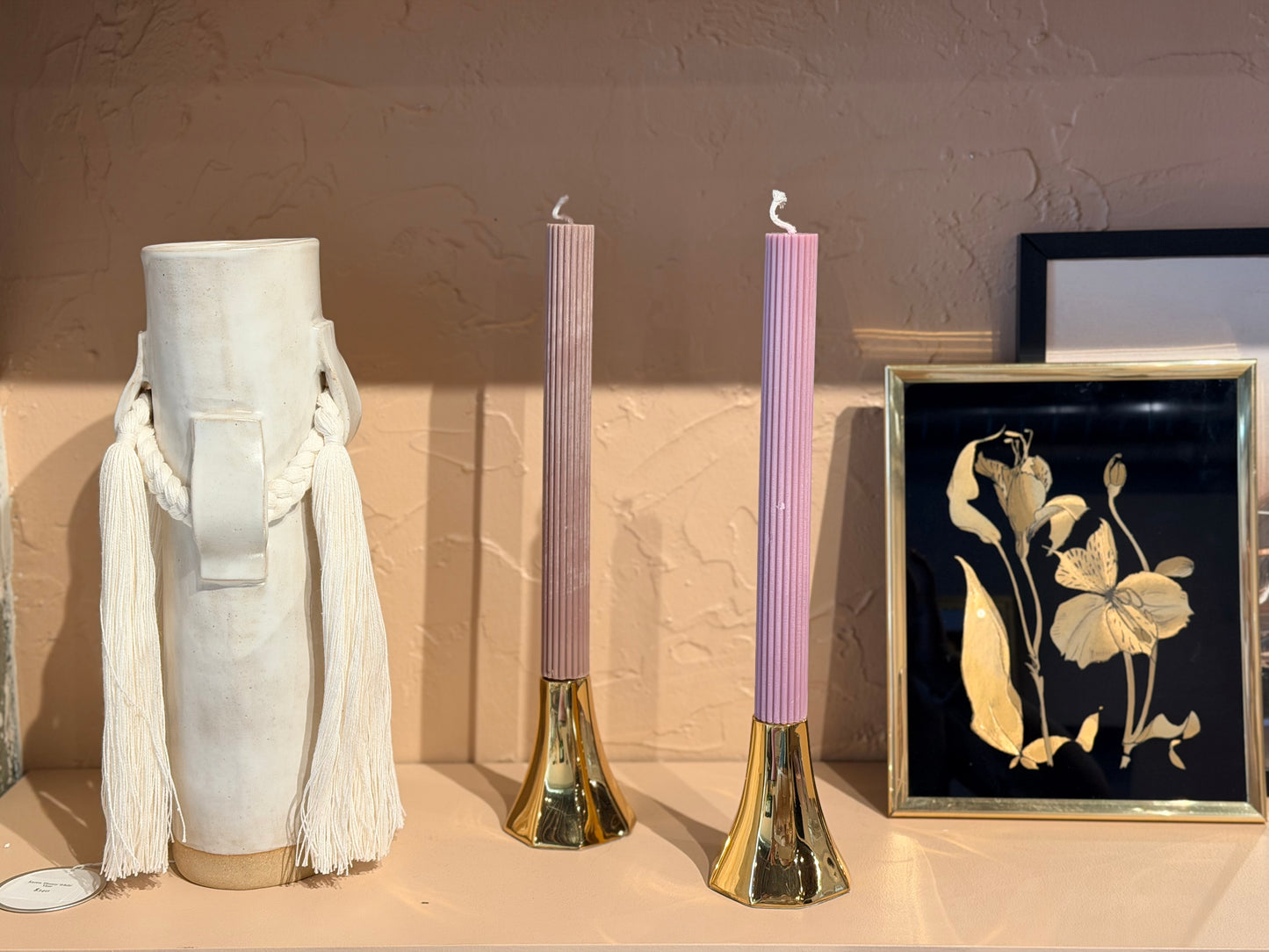 Polished brass tapered candle holders by The Vault Creative, showcasing sleek, shiny metallic finish and elegant tapered design.