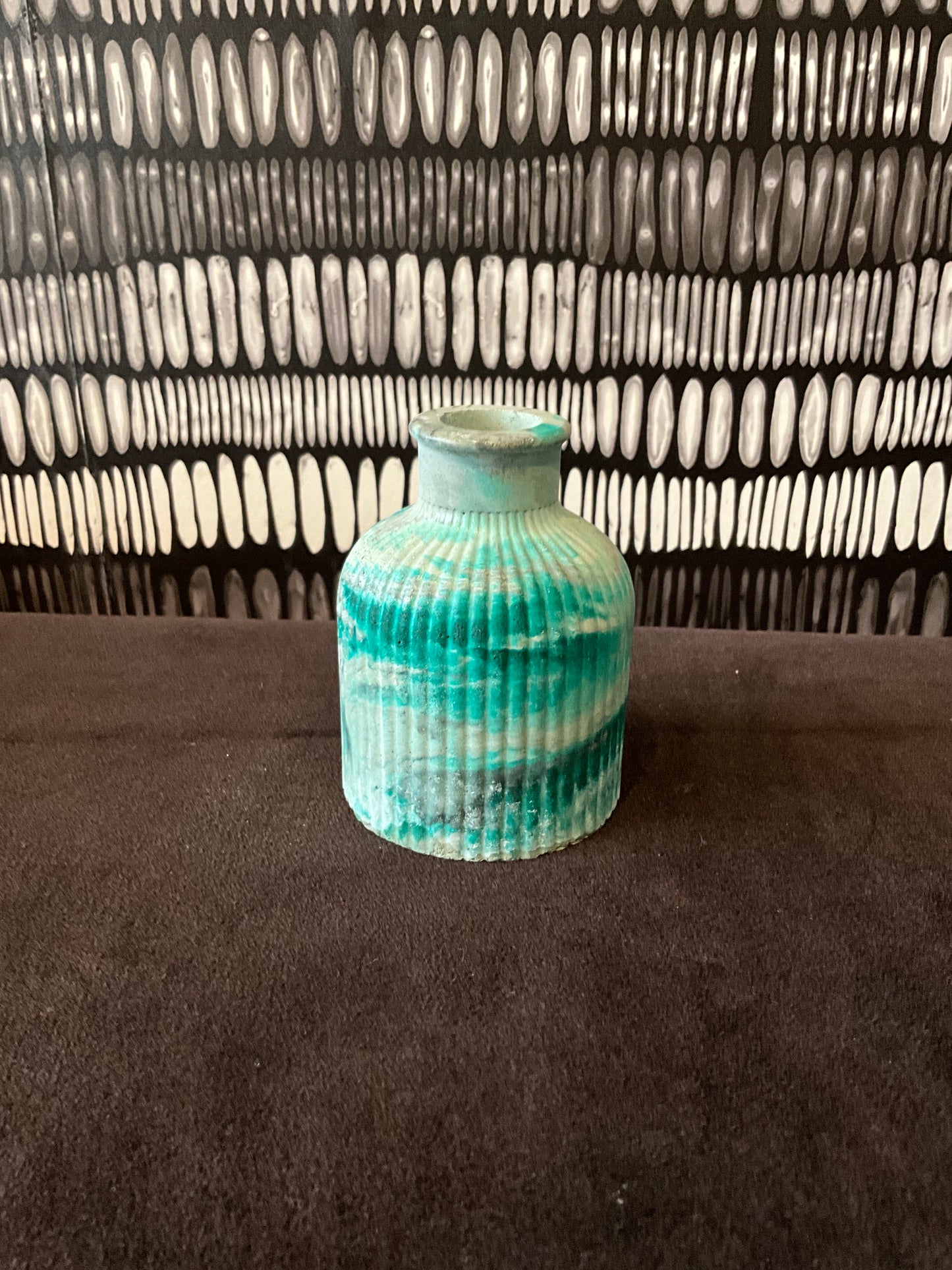 Emerald marble tabletop jar from Stone Textile Studio with a smooth, glossy finish and elegant rounded shape.