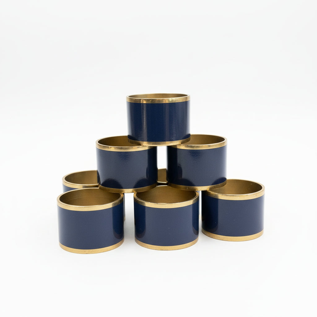 Elegant French brass and enamel napkin rings by Elizabeth, featuring intricate design and colorful enamel accents.